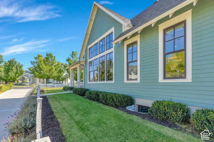 Clapboard siding exterior with white trim, dark-framed windows, and a multi-pane window array
