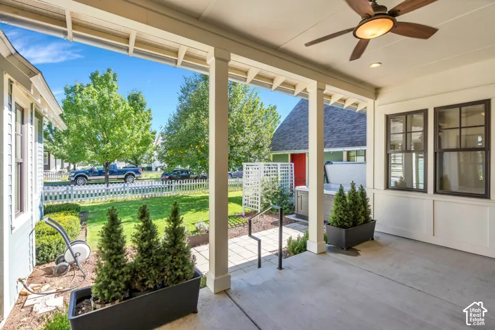 Covered patio featuring a ceiling fan, recessed lighting, and dark-framed windows