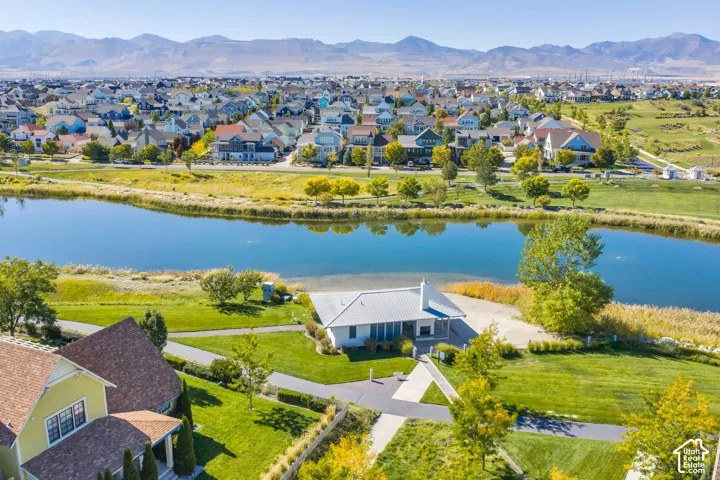 Expansive residential community featuring a prominent pond and mountainous backdrop