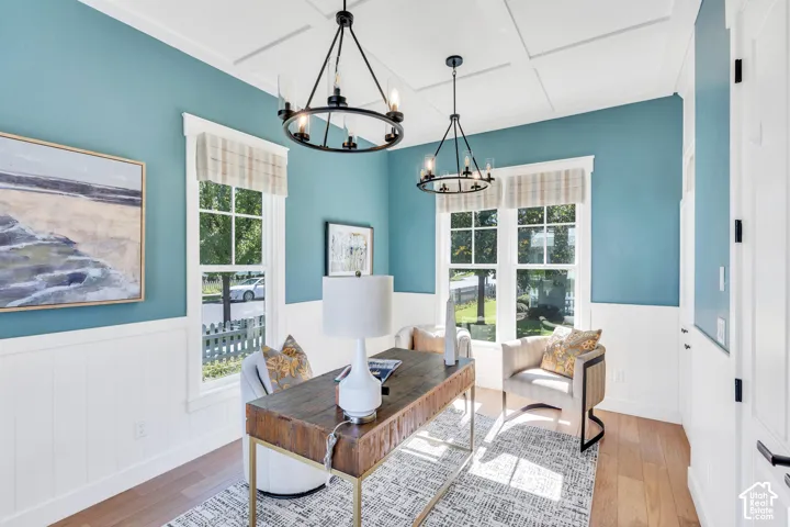 Hardwood flooring, coffered ceiling, wainscoting, double-hung windows, and contemporary chandeliers