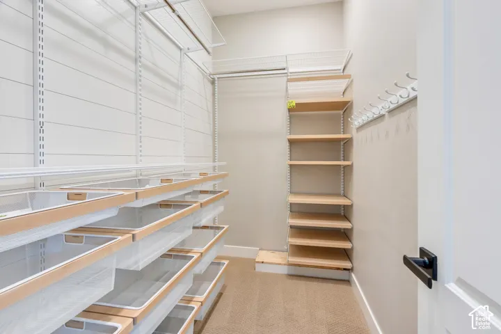 Custom closet system featuring adjustable shelving and integrated storage bins
