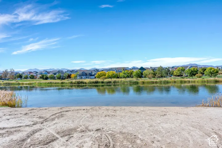 Waterside setting with distant residential properties and mountain backdrop