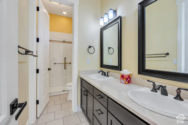 Dual vanity with integrated sinks and dark bronze fixtures, framed mirrors, and a light-toned countertop