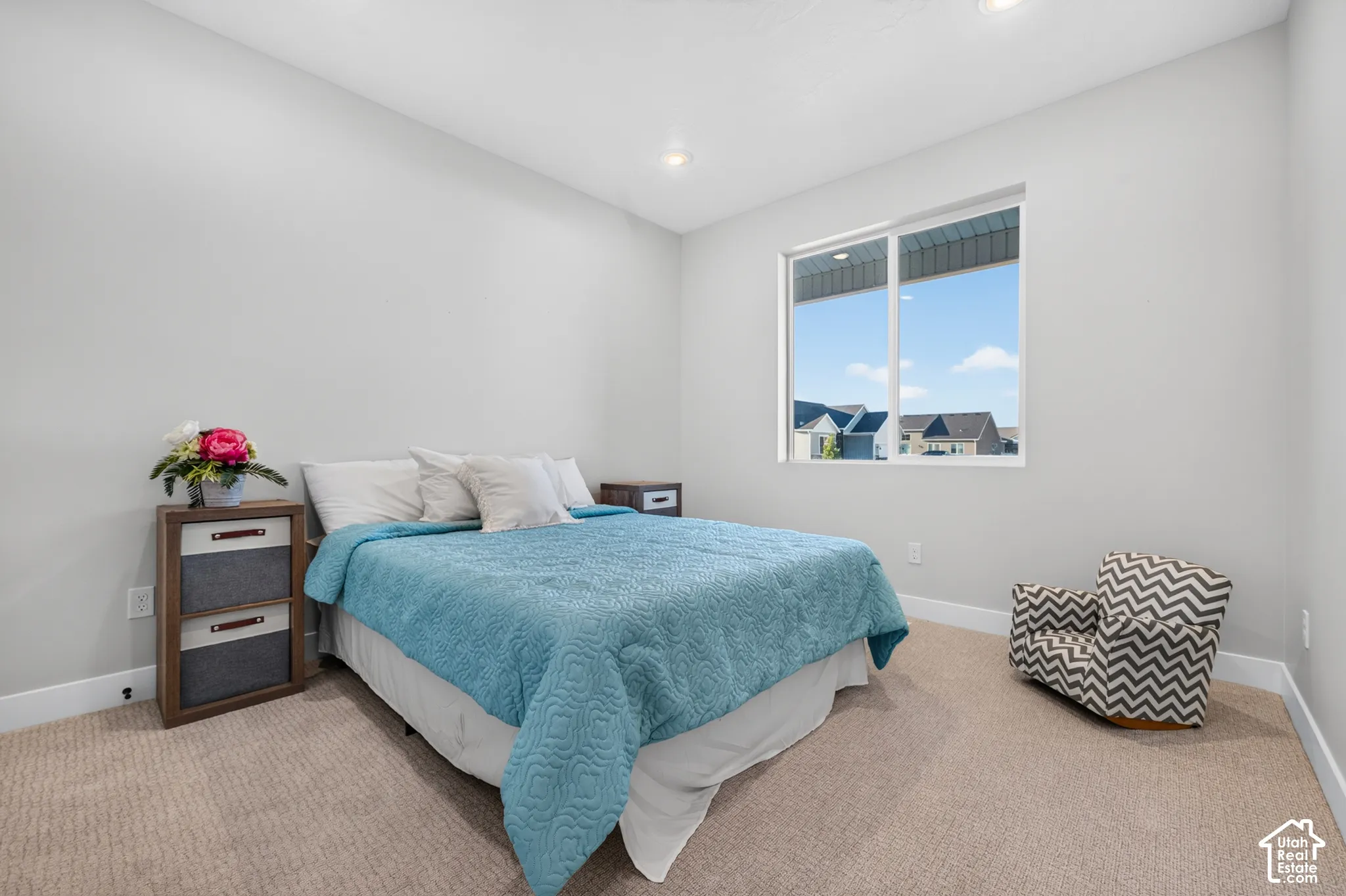 Recessed ceiling lighting, neutral wall finishes, large window with ample natural light, light-toned carpet, and white trim