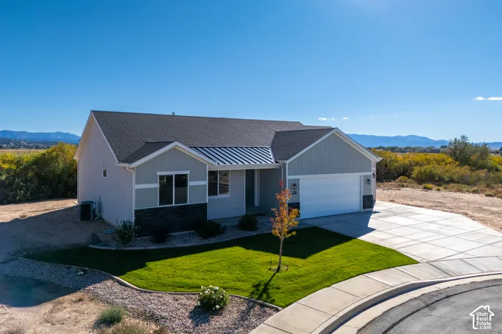 Modern ranch-style residence featuring a combination of siding and stone veneer