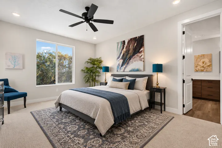 Bright room featuring a large window, recessed lighting, and a ceiling fan