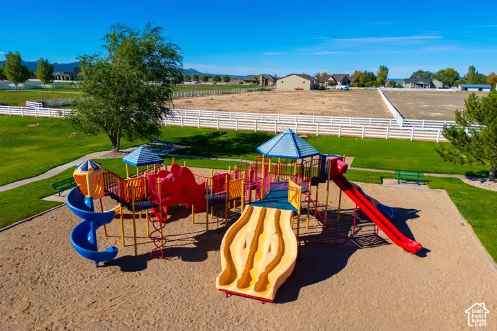 Community playground featuring multiple slides, climbing elements, and sand ground cover