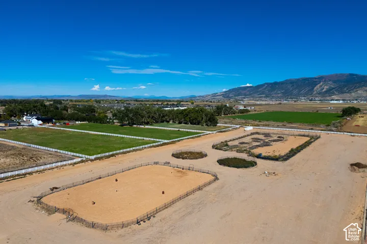 Expansive property featuring multiple fenced paddocks, a large riding arena, and substantial land parcels