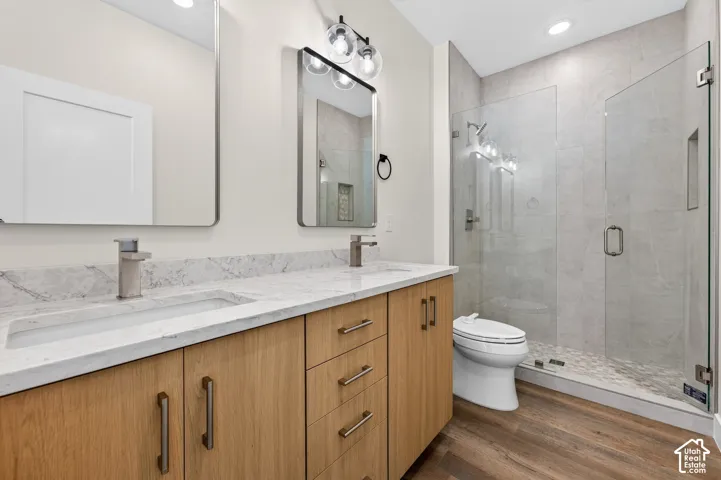 Dual vanity with undermount sinks, stone countertops, and wood-finish cabinetry