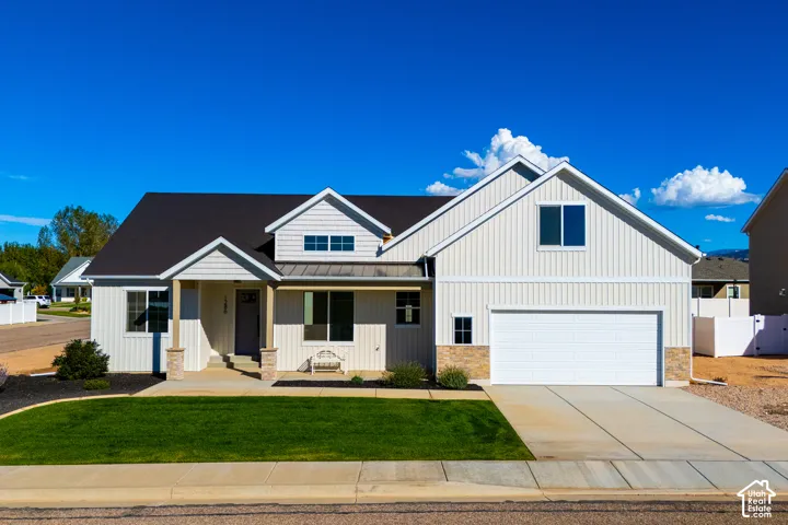 Contemporary exterior with vertical panel siding, dark shingle roof, and stone facade accents