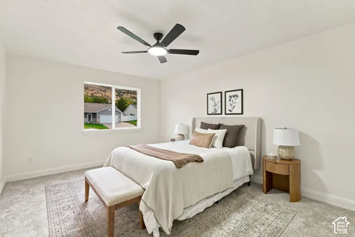 Recessed lighting, ceiling fan, and large window with mountain scenery