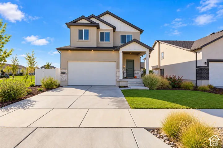Two-story exterior featuring a stone and stucco fa