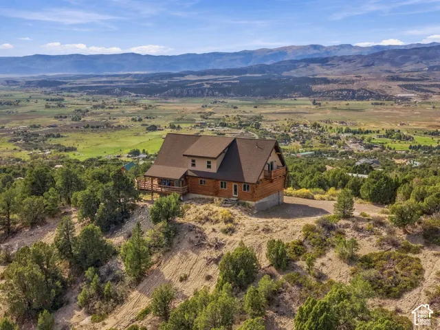 Log cabin construction featuring a multi-level design and a prominent exterior deck