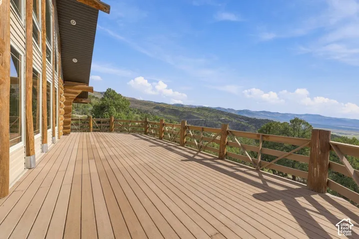 Expansive composite deck with a rustic wooden railing, offering an elevated outdoor living area