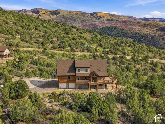 Multi-level home with wood siding and a covered deck