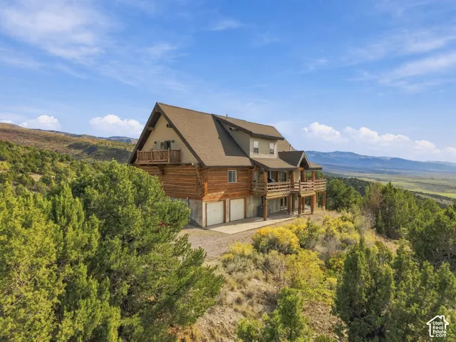 Multi-level residence featuring log-style siding and multiple balconies