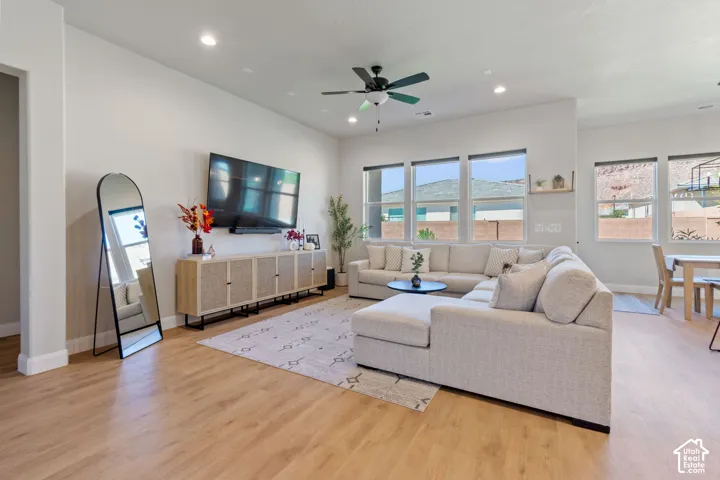 Recessed lighting, ceiling fan, wood-finish flooring, multiple windows, and a built-in wall shelf