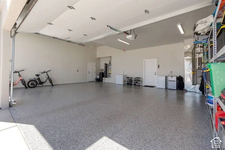 Epoxy-coated flooring, white walls, and a white garage door