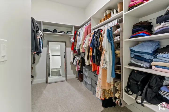 Built-in custom shelving, hanging rods, and ample storage compartments