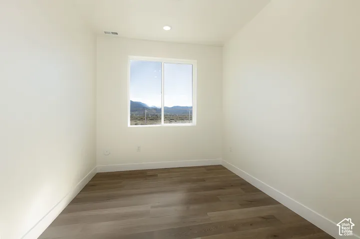 Recessed ceiling lighting, wood-finish flooring, and a large window