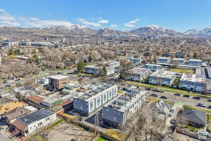 Aerial perspective showcasing urban surroundings and distant snow-capped mountains