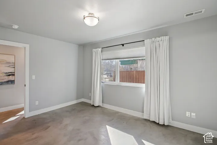 Light gray walls and concrete-finish flooring