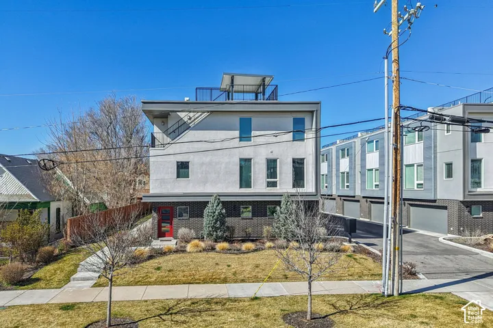 Contemporary architectural design featuring a flat roofline and a rooftop deck