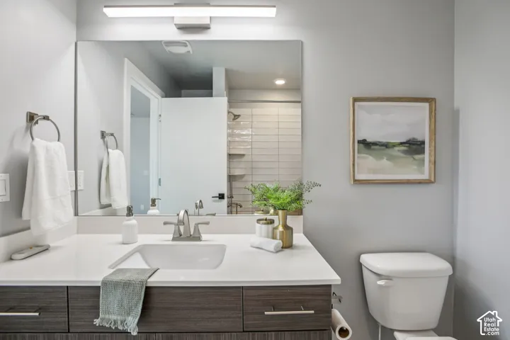 White rectangular sink with a chrome faucet, set into a white countertop