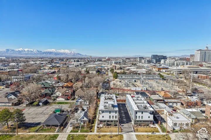 Urban setting with distant mountain range, residential architecture, and commercial buildings