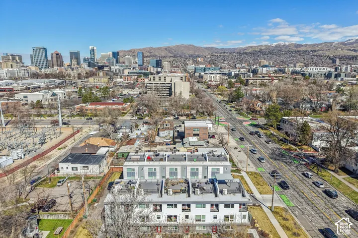 Urban setting with a prominent city skyline and distant mountains