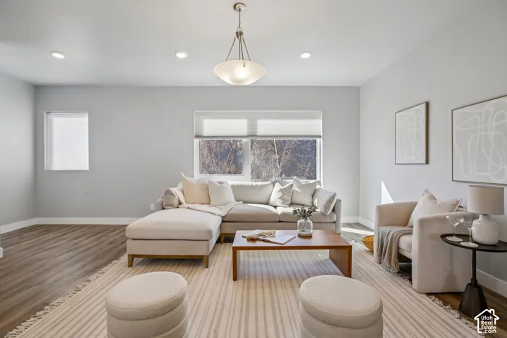 Recessed lighting, wood-finish flooring, and a contemporary ceiling fixture