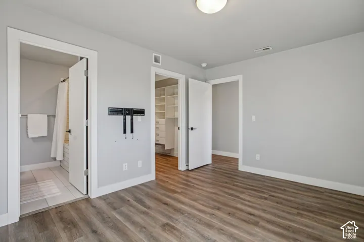 Wood-finish flooring, light gray wall paint, and white trim accents