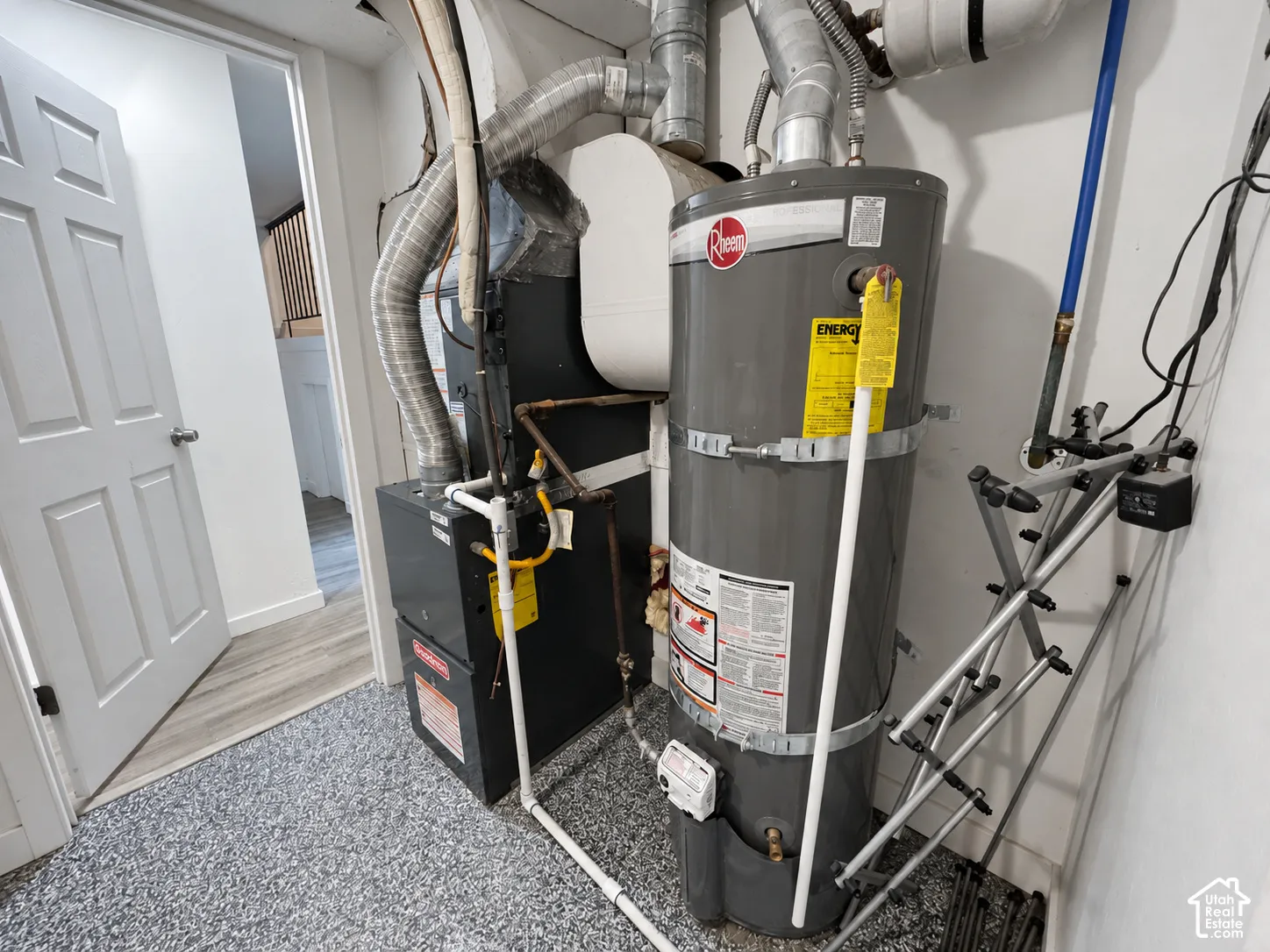 Water heater and furnace, with a textured grey flooring