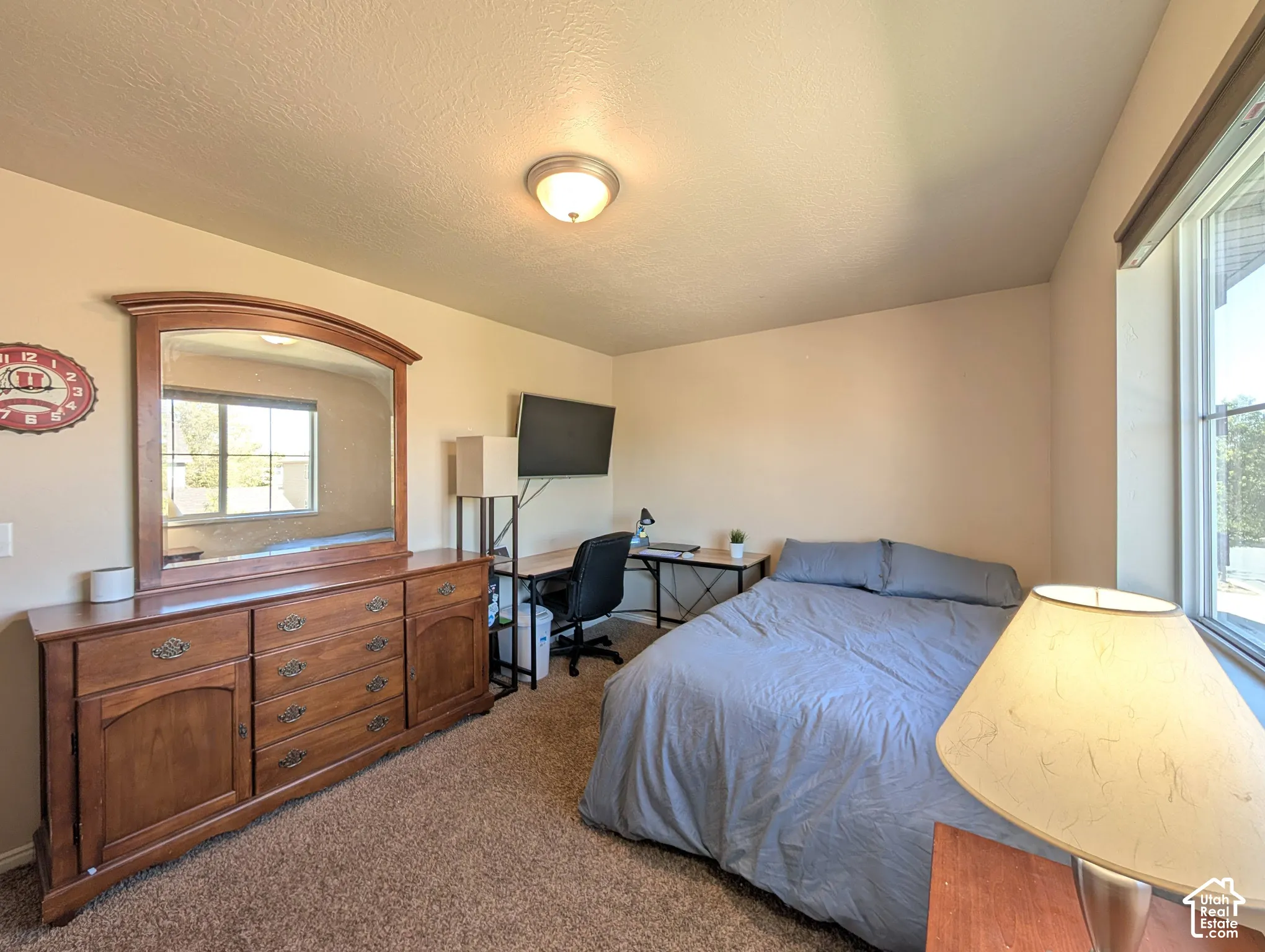 Carpeted flooring, neutral wall color, and a ceiling-mounted light fixture