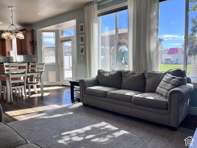 Hardwood-finish flooring, built-in cabinetry, pendant light fixture, abundant natural light, and a backyard area