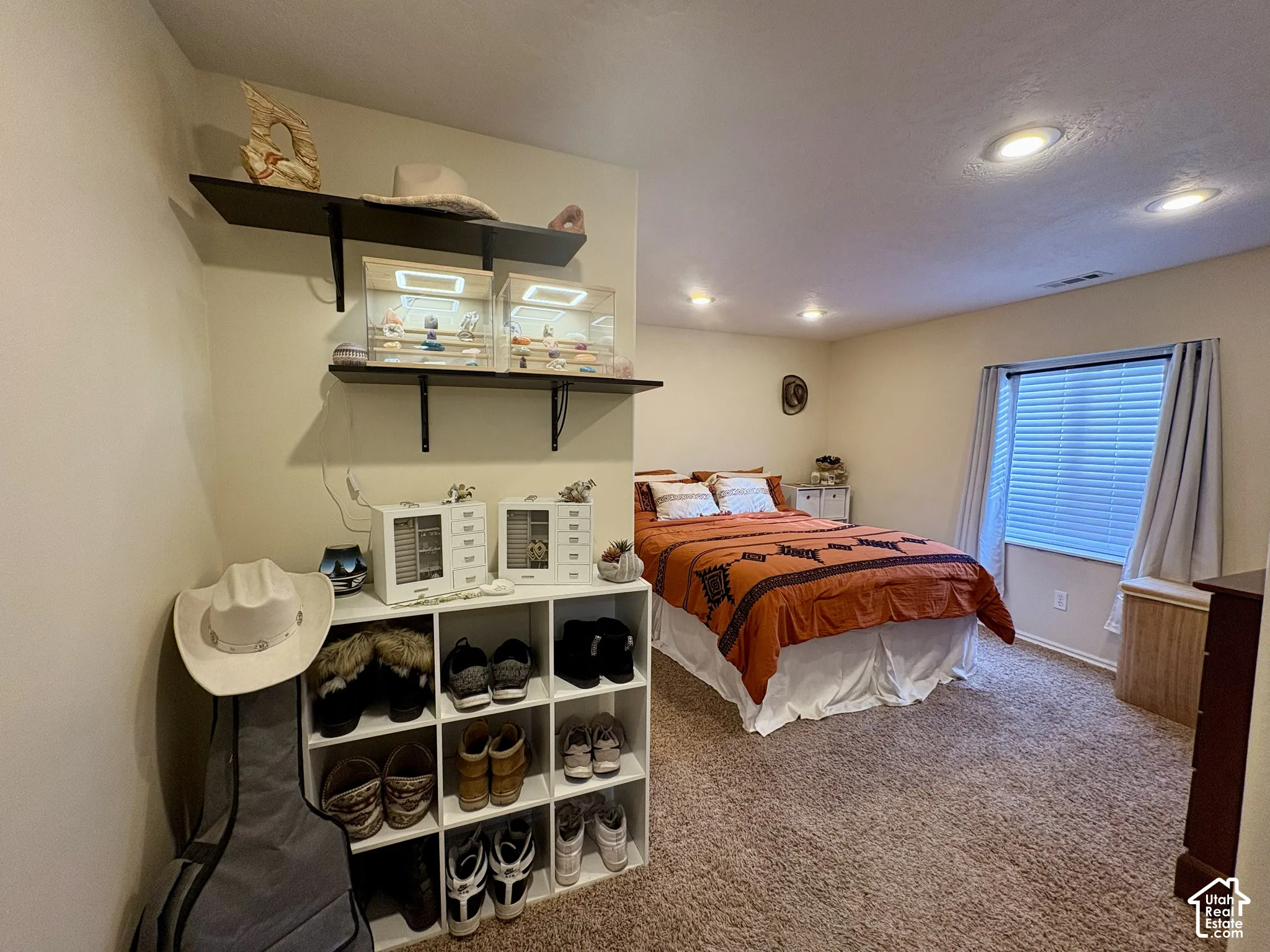 Recessed lighting and a window with blinds provide illumination