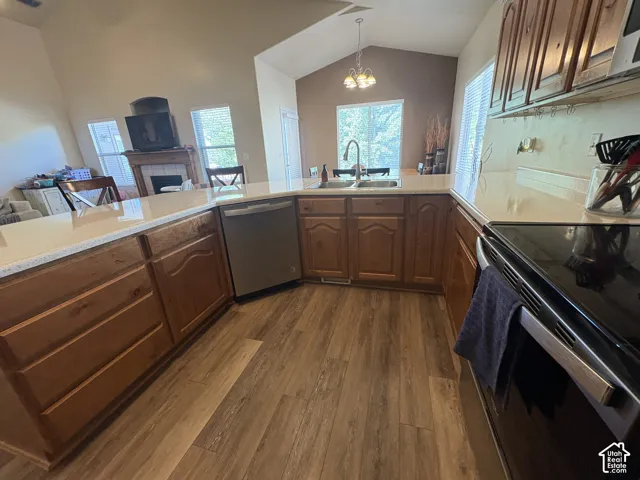 Kitchen featuring wood-finish flooring, light-toned countertops, and wood cabinetry