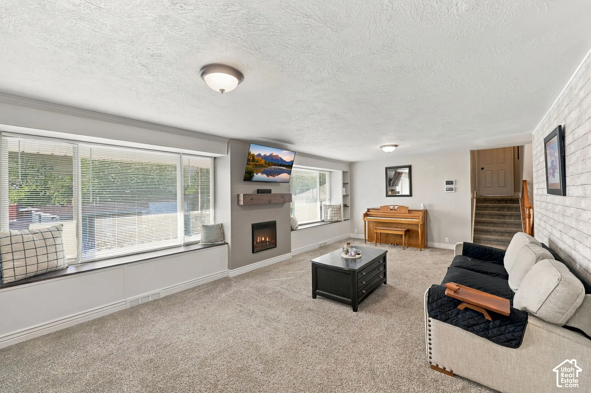 Wall-mounted fireplace with an integrated wood-finish mantel