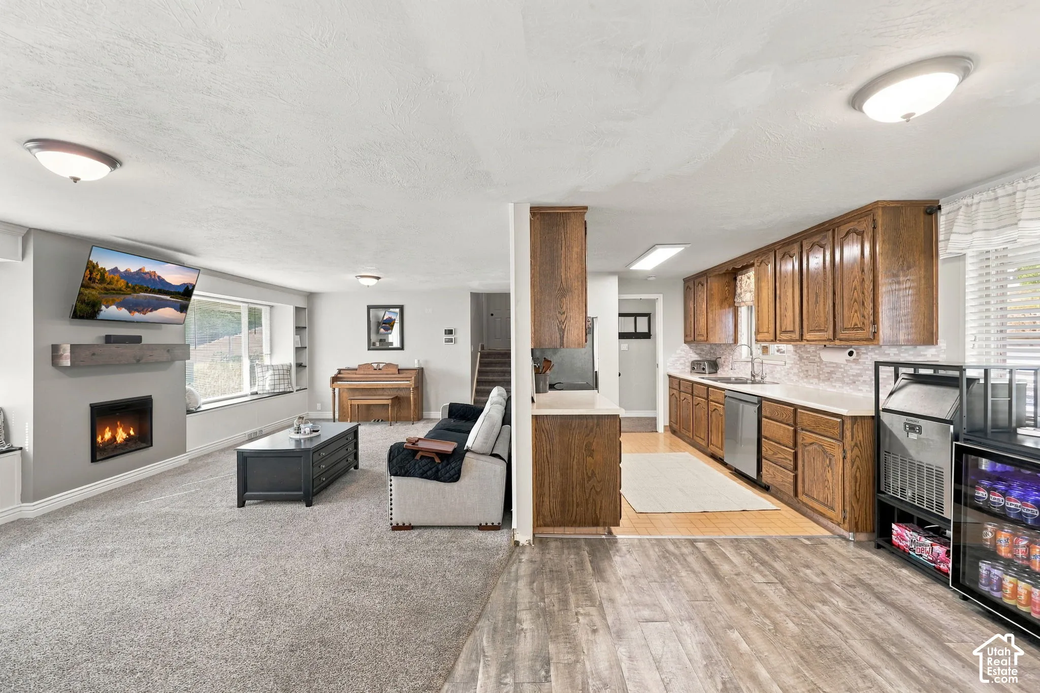 Open-concept living space featuring a fireplace, built-in shelving, and a window seat