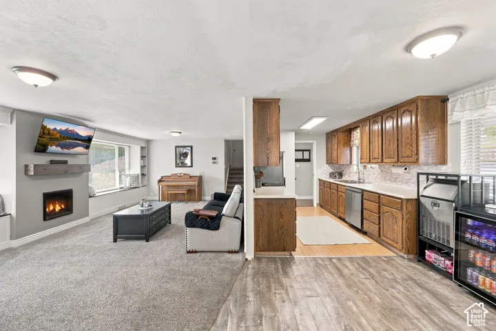 Open-concept living space featuring a fireplace, built-in shelving, and a window seat