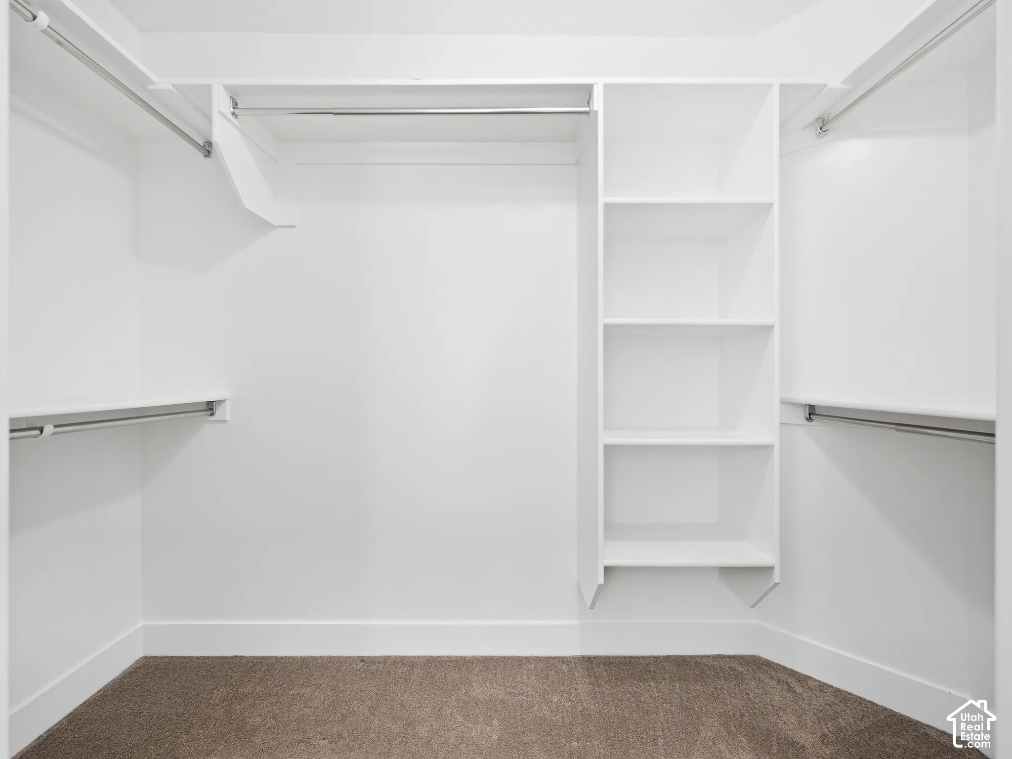 Built-in shelving, multiple hanging rods, and ample storage space