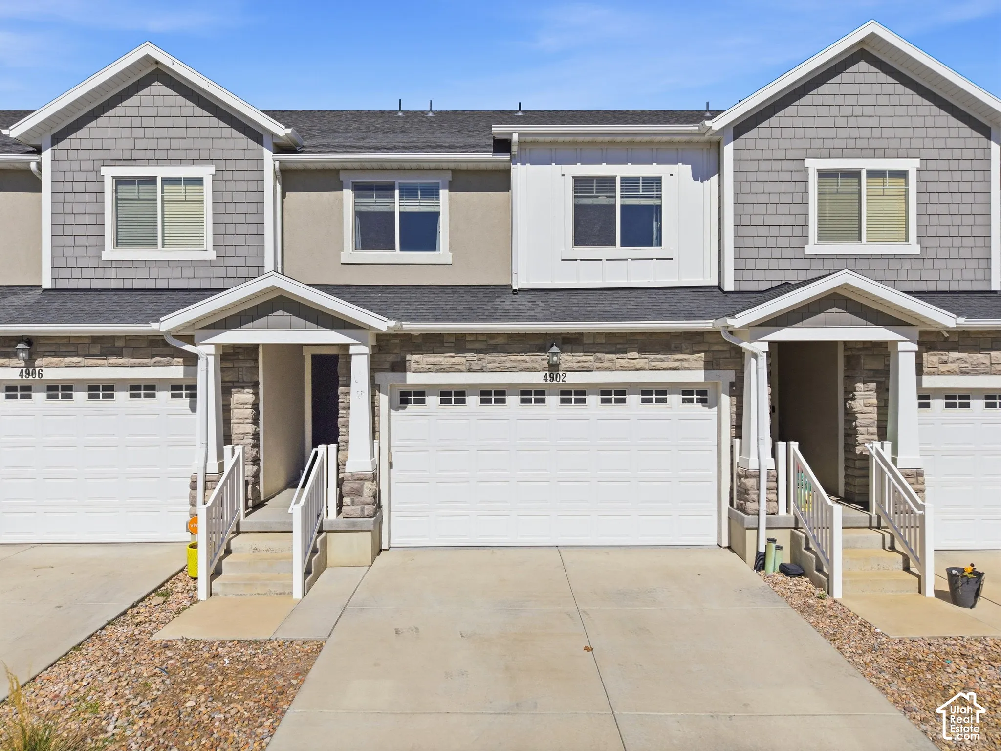 Exterior featuring stone veneer and shingle siding accents