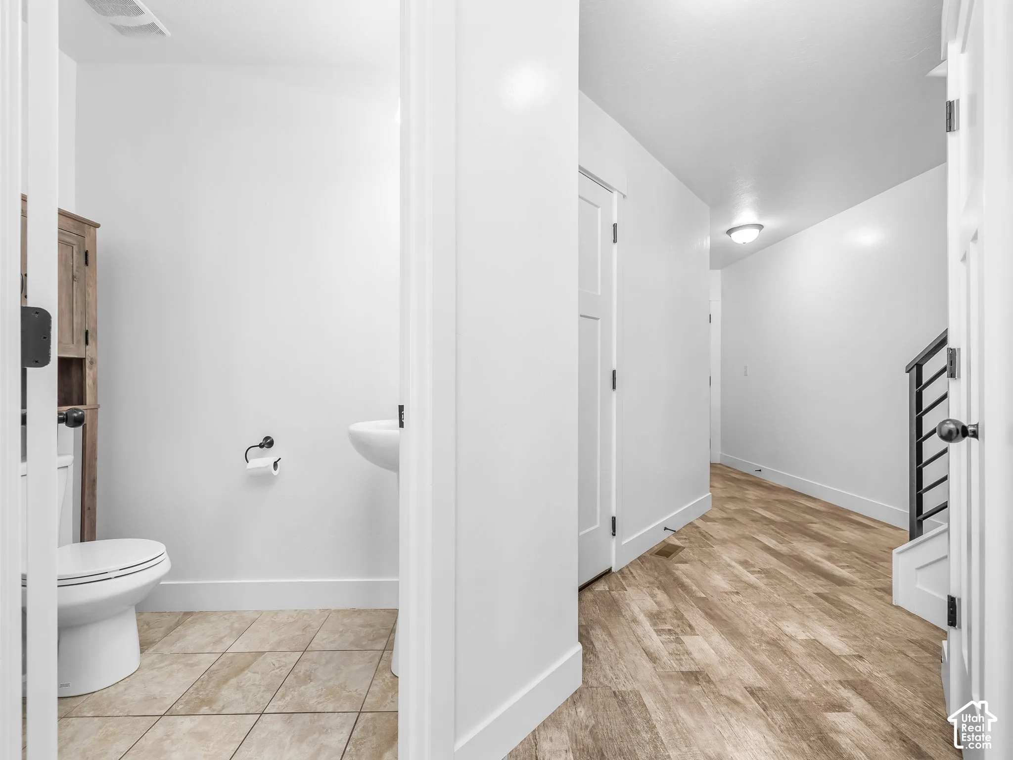 Half bathroom with pedestal sink and tiled flooring