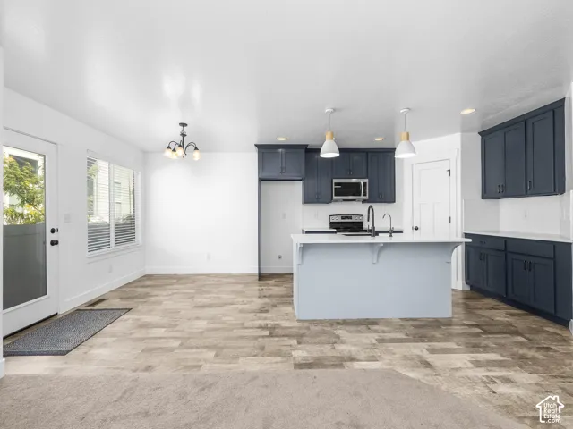 Kitchen featuring dark blue cabinetry, white countertops, and a subway tile backsplash