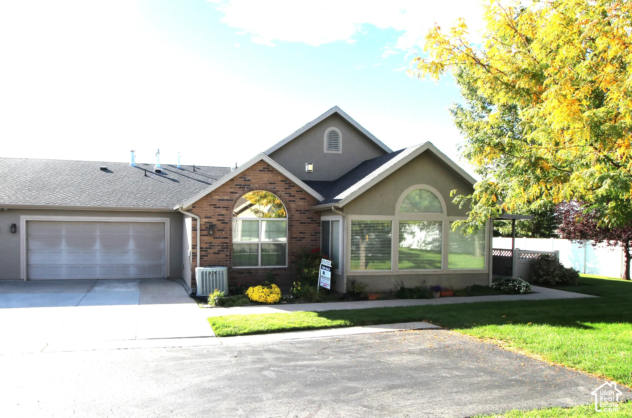 Brick and stucco exterior with an attached two-car garage
