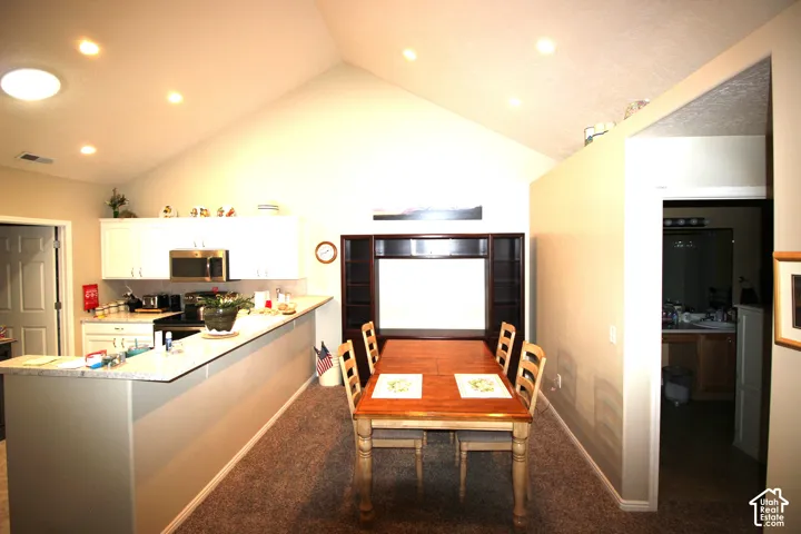 Vaulted ceiling with recessed lighting and a skylight