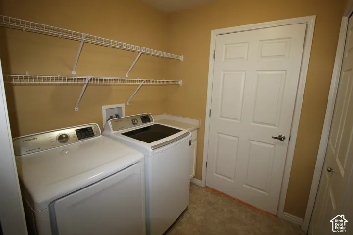 Laundry room featuring dual-level white wire shelving, a built-in cabinetry counter, and a six-panel door
