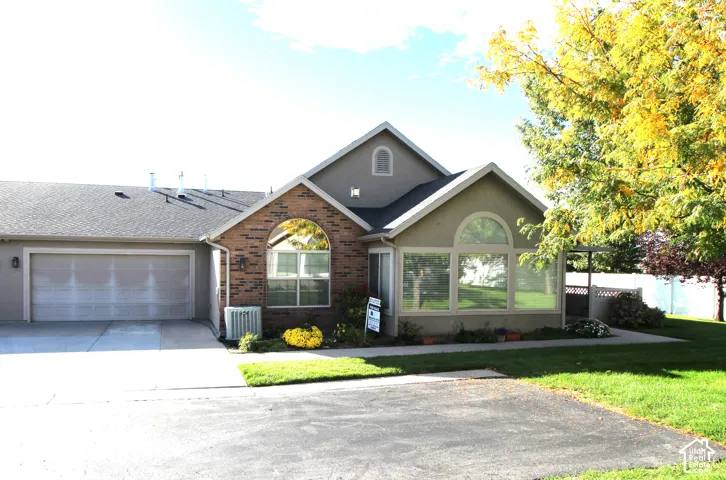 Brick and stucco exterior with an attached two-car garage