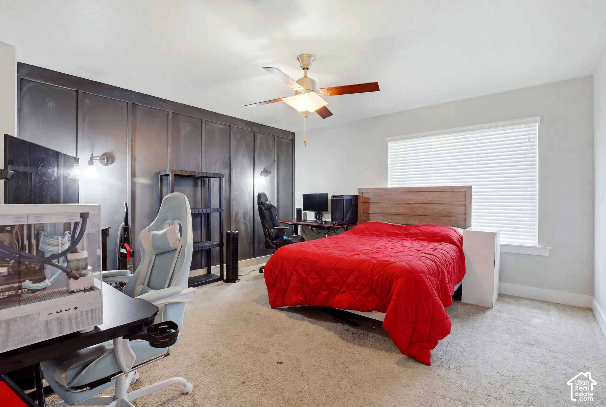 Accent wall featuring a paneled design and sconce lighting