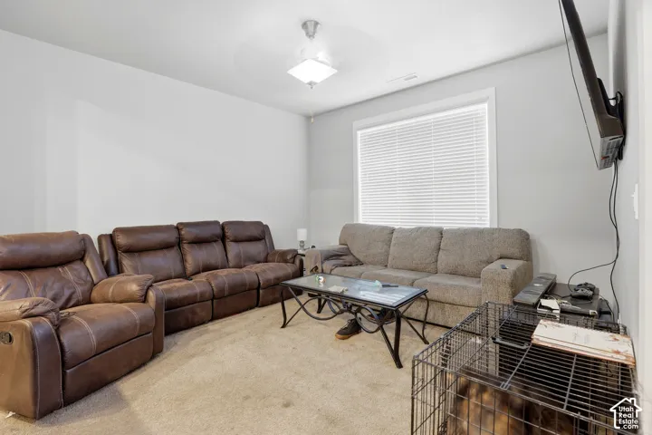 Recessed lighting, neutral wall paint, ceiling-mounted light fixture, window with horizontal blinds, wall-mounted television